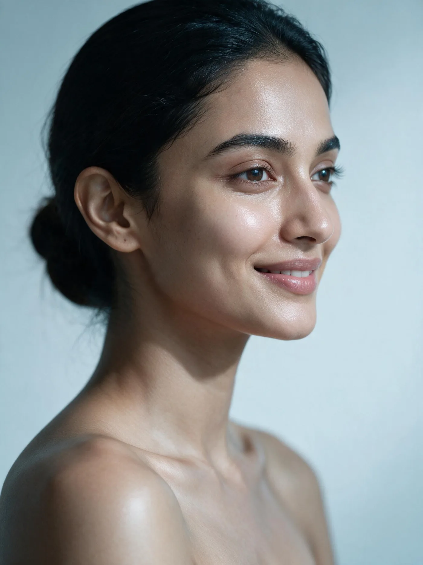 Profile portrait of a woman with luminous, natural, untouched-looking skin