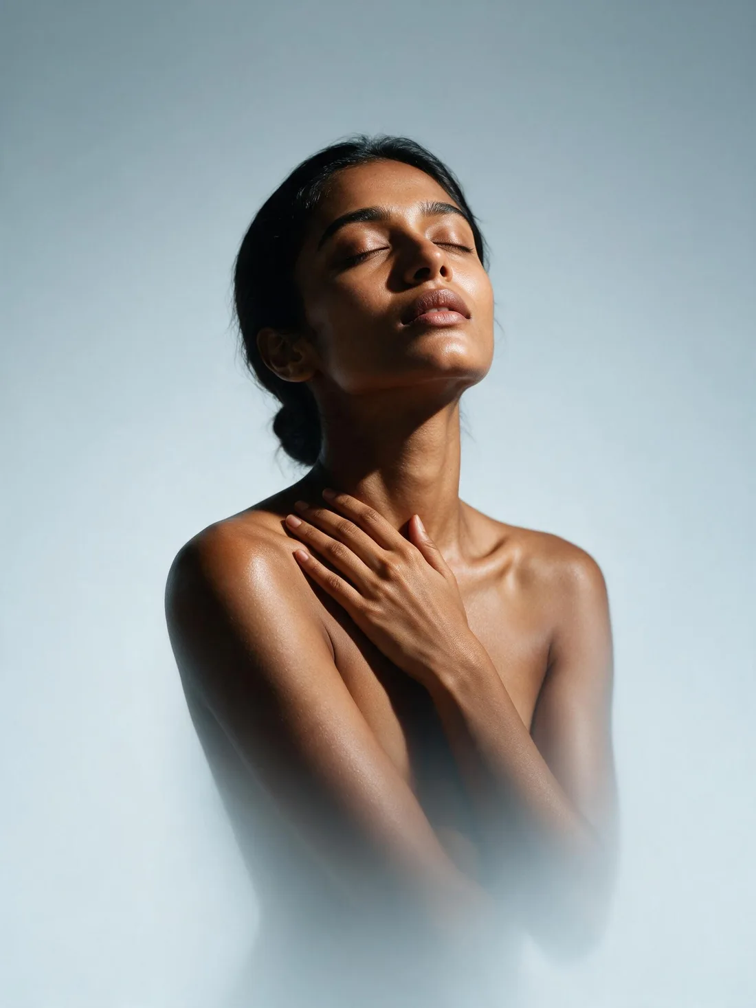 A woman standing relaxed, eyes closed, a picture of whole-body wellbeing